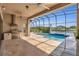 Outdoor living space with built-in grill, spacious patio, and screened-in pool at 13232 Alderley Dr, Orlando, FL 32832