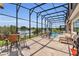 Relaxing screened-in pool area with outdoor seating, dining, and lake views at 13232 Alderley Dr, Orlando, FL 32832