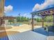 Private backyard features a swimming pool, pergola, patio, and lush green space, ideal for outdoor living at 13735 Sw 73Rd St, Ocala, FL 34481