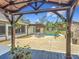The backyard features a pool, outdoor fireplace, and a gazebo perfect for outdoor enjoyment at 13735 Sw 73Rd St, Ocala, FL 34481