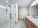 Elegant bathroom with tiled walk-in shower, modern vanity, and decorative tile flooring at 13735 Sw 73Rd St, Ocala, FL 34481