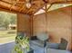 Gazebo with lattice walls featuring ceiling fan, wooden roof, hanging plants and outdoor seating area at 13735 Sw 73Rd St, Ocala, FL 34481