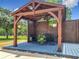 Outdoor gazebo featuring a ceiling fan, lattice walls, patio furniture, and hanging plants at 13735 Sw 73Rd St, Ocala, FL 34481