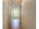 Hallway with wood flooring and access to a bathroom with a standalone tub under a large bright window at 13735 Sw 73Rd St, Ocala, FL 34481