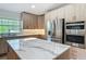 Spacious kitchen featuring a large island, light wood cabinetry, stainless appliances and marble countertops at 13735 Sw 73Rd St, Ocala, FL 34481