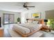 Staged bedroom with wood floors, neutral walls, lots of natural light, and exterior access at 13735 Sw 73Rd St, Ocala, FL 34481