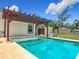 Refreshing in-ground pool features a concrete patio and an outdoor pergola at 13735 Sw 73Rd St, Ocala, FL 34481