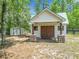 Charming shed featuring wooden doors, stone pillar bases, and a lovely green metal roof at 13735 Sw 73Rd St, Ocala, FL 34481