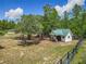 Exterior view of the shed, nicely landscaped and surrounded by mature trees at 13735 Sw 73Rd St, Ocala, FL 34481