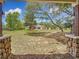 View of backyard with spacious lawn, wooden pergola, outbuilding, and stone pillar details at 13735 Sw 73Rd St, Ocala, FL 34481