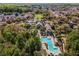 A high angle view of a community pool surrounded by lush landscape and seating areas at 1400 Celebration Ave # 203, Celebration, FL 34747