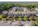 Aerial view shows the apartment complex bordering a pond, surrounded by lush foliage at 1400 Celebration Ave # 203, Celebration, FL 34747