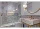 Modern bathroom with marble tile, glass shower, unique marble sink, and gold fixtures at 1400 Celebration Ave # 203, Celebration, FL 34747