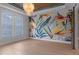 Spacious bedroom with hardwood floors, windows, and stylish lighting at 1400 Celebration Ave # 203, Celebration, FL 34747