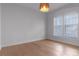 Bright bedroom with hardwood floors, modern light fixture, and natural light from the windows at 1400 Celebration Ave # 203, Celebration, FL 34747