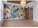 Bright bedroom with hardwood flooring, a statement wall, and a stylish light fixture at 1400 Celebration Ave # 203, Celebration, FL 34747