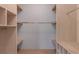 Walk-in closet featuring custom wood shelving for organized storage at 1400 Celebration Ave # 203, Celebration, FL 34747