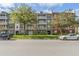 Stately condominium building featuring multiple balconies and manicured landscaping at 1400 Celebration Ave # 203, Celebration, FL 34747