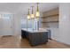 Modern kitchen featuring an island with cooktop, designer tile backsplash, and stainless appliances at 1400 Celebration Ave # 203, Celebration, FL 34747