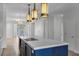 Open kitchen features cooktop island with seating and view of living space with lots of natural light at 1400 Celebration Ave # 203, Celebration, FL 34747