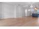 Open-concept living space with hardwood floors, neutral walls, and kitchen view at 1400 Celebration Ave # 203, Celebration, FL 34747