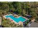 Aerial view of community pool area surrounded by palm trees and lounge chairs at 1400 Celebration Ave # 203, Celebration, FL 34747
