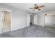 A spacious bedroom boasts plush carpet, a ceiling fan, and a mirrored closet door at 1635 Little Falls Cir, Orlando, FL 32807
