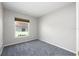 Neutral bedroom with a window, gray carpet, and white walls offers a calm and inviting space at 1635 Little Falls Cir, Orlando, FL 32807