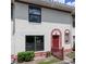 Condominium exterior with well-maintained landscaping, red accents, and neutral exterior at 1635 Little Falls Cir, Orlando, FL 32807