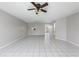 Open-concept living room featuring tiled floors, ceiling fans, and access to backyard at 1635 Little Falls Cir, Orlando, FL 32807