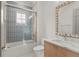 Bathroom with tub-shower, tile surround, modern fixtures, vanity, and framed mirror at 1820 Glencoe Rd, Winter Park, FL 32789