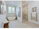 Luxurious bathroom with a freestanding tub, glass-enclosed shower, and elegant marble finishes at 1820 Glencoe Rd, Winter Park, FL 32789
