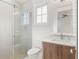 Bright bathroom featuring a tiled shower with sliding glass door, and a modern vanity at 1820 Glencoe Rd, Winter Park, FL 32789
