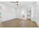 Bright bedroom featuring an ensuite bathroom, walk-in closet, and hardwood flooring at 1820 Glencoe Rd, Winter Park, FL 32789