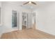 Bright bedroom featuring an ensuite bathroom, walk-in closet, and hardwood flooring at 1820 Glencoe Rd, Winter Park, FL 32789