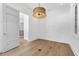 Bright bonus room featuring a modern light fixture, hardwood floors and neutral color palette at 1820 Glencoe Rd, Winter Park, FL 32789