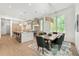 Open-concept dining area adjacent to the kitchen, featuring a stylish table and chairs on a patterned rug at 1820 Glencoe Rd, Winter Park, FL 32789