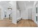 Welcoming entryway with custom trim, modern light fixtures, a built-in bench, and hardwood flooring at 1820 Glencoe Rd, Winter Park, FL 32789