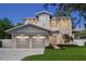 Stunning two-story home with a two-car garage, manicured lawn and stone driveway at twilight at 1820 Glencoe Rd, Winter Park, FL 32789
