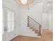 Inviting foyer features a modern staircase, wood floors, and a bright, open feel at 1820 Glencoe Rd, Winter Park, FL 32789