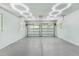 Spacious two-car garage with a clean epoxy floor and modern lighting fixtures illuminating the area at 1820 Glencoe Rd, Winter Park, FL 32789