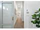 Bright hallway with wood flooring, white walls, and modern accents, leading to other rooms at 1820 Glencoe Rd, Winter Park, FL 32789
