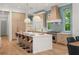 Bright, modern kitchen with a large island, pendant lighting, and stainless steel appliances at 1820 Glencoe Rd, Winter Park, FL 32789