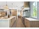 Well-appointed kitchen with custom cabinetry, high-end appliances, and open layout at 1820 Glencoe Rd, Winter Park, FL 32789