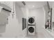 Laundry room with stacked washer and dryer and built in shelves at 1820 Glencoe Rd, Winter Park, FL 32789