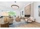 Elegant living room with a fireplace, hardwood floors, and open layout at 1820 Glencoe Rd, Winter Park, FL 32789