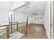 Bright loft area with hardwood floors, neutral paint, modern light fixtures, and ample windows at 1820 Glencoe Rd, Winter Park, FL 32789