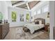 Light-filled main bedroom with vaulted ceiling, wood floors, and ample natural light from multiple windows at 1820 Glencoe Rd, Winter Park, FL 32789