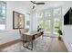 Bright office space with large windows, modern desk, and hardwood floors at 1820 Glencoe Rd, Winter Park, FL 32789
