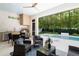 Inviting outdoor space with a built-in grill, sink, and seating area next to the refreshing swimming pool at 1820 Glencoe Rd, Winter Park, FL 32789
